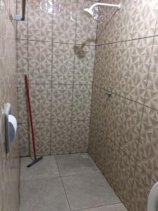 a shower with a glass door in a bathroom at Pousada Vidal in Carolina