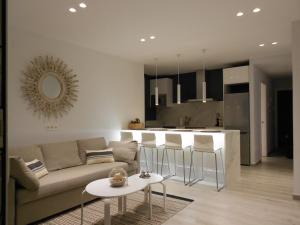 a living room with a couch and a kitchen at Luxury Apartment Cambrils in Cambrils