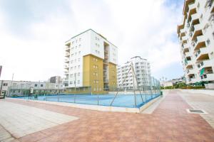 a pool in the middle of two tall buildings at Peñiscola playa in Peñíscola +8 photos