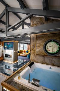 a large bath tub in the middle of a room at Architect's Loft in Windermere