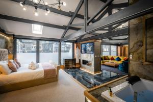 a master bedroom with a bed and a fireplace at Architect's Loft in Windermere