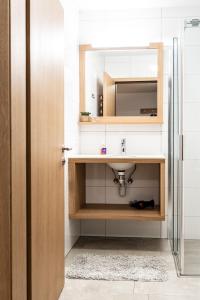 a bathroom with a sink and a mirror at Faschina Apartment - Top 1 in Fontanella