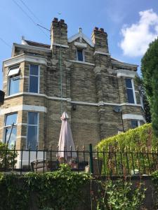 une vieille maison avec un parasol devant elle dans l'établissement Coniston Guest House, à Sheffield