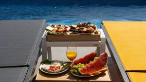 a tray of food and fruit on a boat at Antigoni Villas in Gavrio