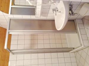 a bathroom with a sink and a toilet at Hotel Gästehaus Neubauer in Kaltenberg