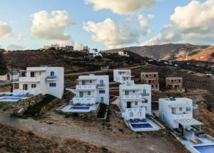 an aerial view of white buildings on a hill at Antigoni Villas in Gavrio
