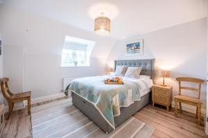 a bedroom with a bed and a chair at 10 Acorn Close Aldringham in Leiston