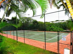 a tennis court with a net on a tennis court at Laguna la Crete 214 in Uvongo Beach