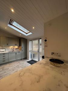 a large kitchen with a skylight in the ceiling at Lowena Lodge in Troutbeck