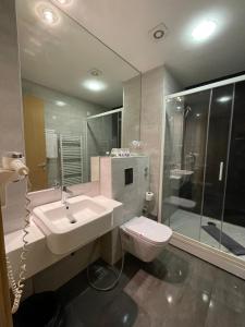 a bathroom with a sink and a toilet and a shower at Spa Hotel Terme in Sarajevo
