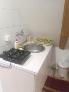 a kitchen counter with a sink and a stove at Apartmani Jovičić in Užice +5 photos