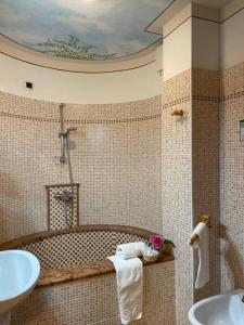 a bathroom with a bath tub and a sink at Hotel San Lorenzo in San Lorenzo in Banale