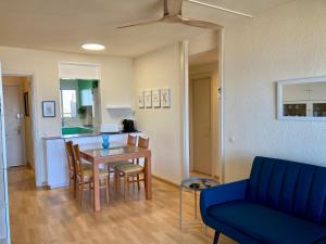 a living room with a table and chairs and a kitchen at Voramar Viu Bé in L'Estartit