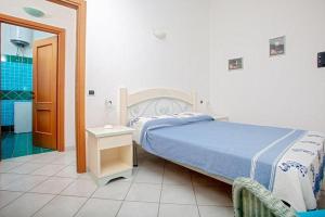 a bedroom with a large bed and a bathroom at Casa Ginevra in Santa Teresa Gallura