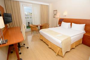 a hotel room with a bed and a desk and a window at Holiday Inn Istanbul City, an IHG Hotel in Istanbul