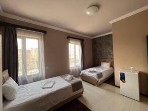 a hotel room with two beds and a window at RP HOTEL (NEW) in Yerevan