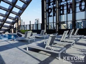 a row of white lounge chairs on a building at KeyOne - 1BR in Sparkle Tower in Dubai
