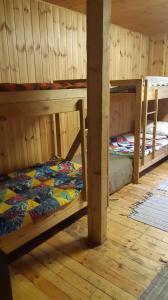 a room with two bunk beds in a cabin at Tammispea puhkeküla 