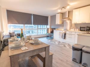 a kitchen and living room with a table in a room at Pass the Keys Nottingham City Centre One Bed Apartment in Nottingham
