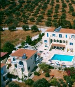 an aerial view of a large house with a swimming pool at Lianos Hotel Apartments in Spetses