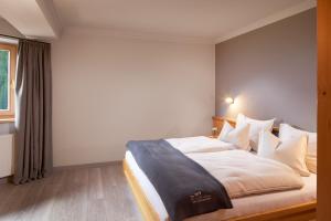 A bed or beds in a room at Adler Inn Tyrol Mountain Resort SUPERIOR