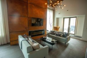 a living room with two couches and a fireplace at Tuscany by LuxUrban, Trademark Collection by Wyndham in New York