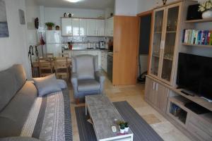 a living room with a couch and a table at Apartamento del Mar - Fewo am Meer Algarrobo Costa in Algarrobo-Costa