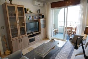 a living room with a large entertainment center with a television at Apartamento del Mar - Fewo am Meer Algarrobo Costa in Algarrobo-Costa