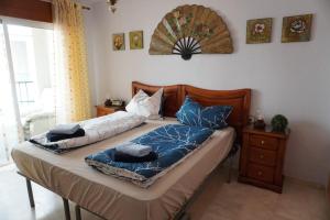 a bed with two pillows on it in a bedroom at Apartamento del Mar - Fewo am Meer Algarrobo Costa in Algarrobo-Costa