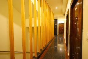 a hallway with wooden dividers in a building at Hotel Vijaya Grand in Srikalahasti