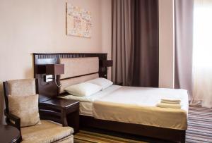 Postel nebo postele na pokoji v ubytování Guru Hotel