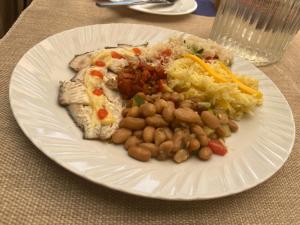 a white plate of food with beans and rice at Ranges View Lodge Staycation in Kiamuturi