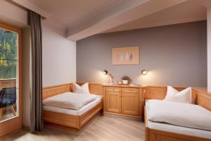 A bed or beds in a room at Adler Inn Tyrol Mountain Resort SUPERIOR