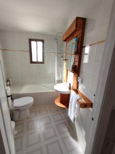 a bathroom with a sink and a toilet and a tub at El Cortijo del Piron in Losana de Pirón +18 photos