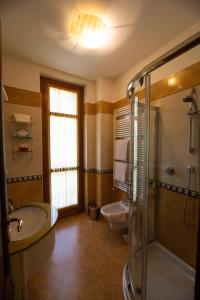 a bathroom with a tub and a sink and a shower at Villa Teresa in Limone Piemonte