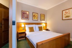 Postel nebo postele na pokoji v ubytování Hotel Abácie & Wellness