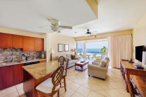 a kitchen and living room with a view of the ocean at Coral Gardens on Grace Bay in Grace Bay