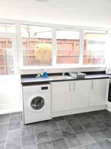 a kitchen with a washing machine and a sink at Eastgate Road in Middlesbrough