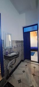 a bathroom with a sink and a mirror on the wall at Riad chaoui house in Marrakech