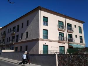 a man riding a scooter in front of a building at Torredembarra in Torredembarra