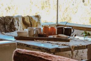a table with a tray of food and utensils in a window at Refugio Inka in Los Molles +23 photos