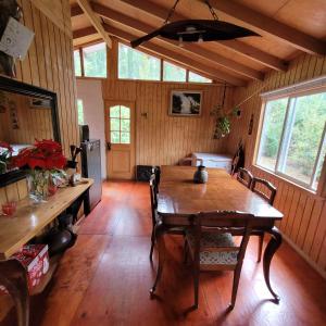 a dining room with a wooden table in a house at Entre Esteros in San Pablo +7 photos