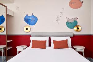 a bedroom with a bed with orange pillows at Turtle's Inn Hotel in Hurghada