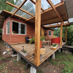 a house with a wooden deck with a solar roof at Entre Esteros in San Pablo