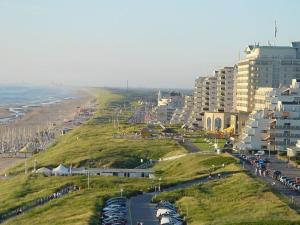 a view of a city with a beach and buildings at ZeeBedStay in Noordwijk aan Zee
