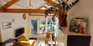 a living room with a staircase and a vase with a plant at Natuurhuisje Heerlijkheid Beek in Berg en Dal