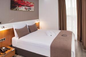 Postel nebo postele na pokoji v ubytování Buca Residence Hotel