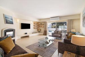 a living room with a couch and a fireplace at Villa Nicola in Vale do Lobo