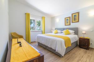 a bedroom with a large bed and a window at Casa Dean by Algarve Golden Properties in Lagos