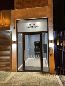 an entrance to a building with a glass door at Whole apartment in Harrow Town centre in Harrow